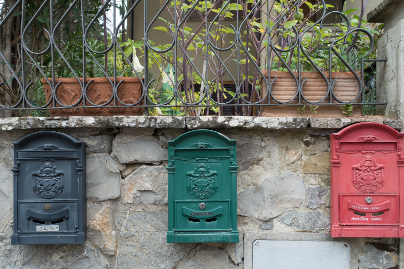 New black mailbox installed on a post with hardware and tools nearby
